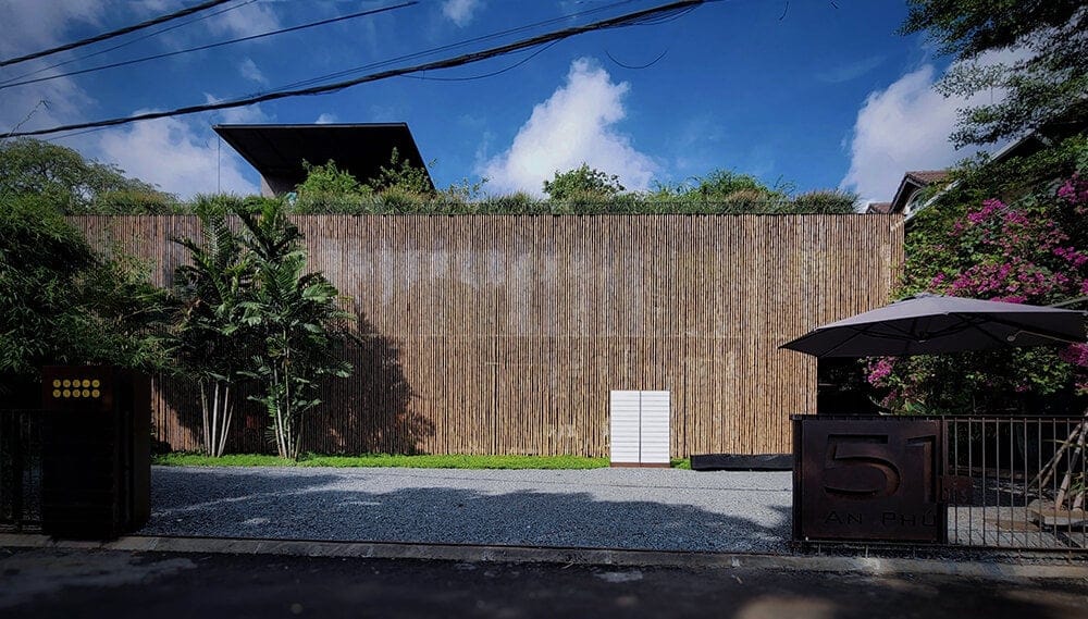 bamboo screens, glass, and climbing plants engulf 'the vibes' complex in vietnam